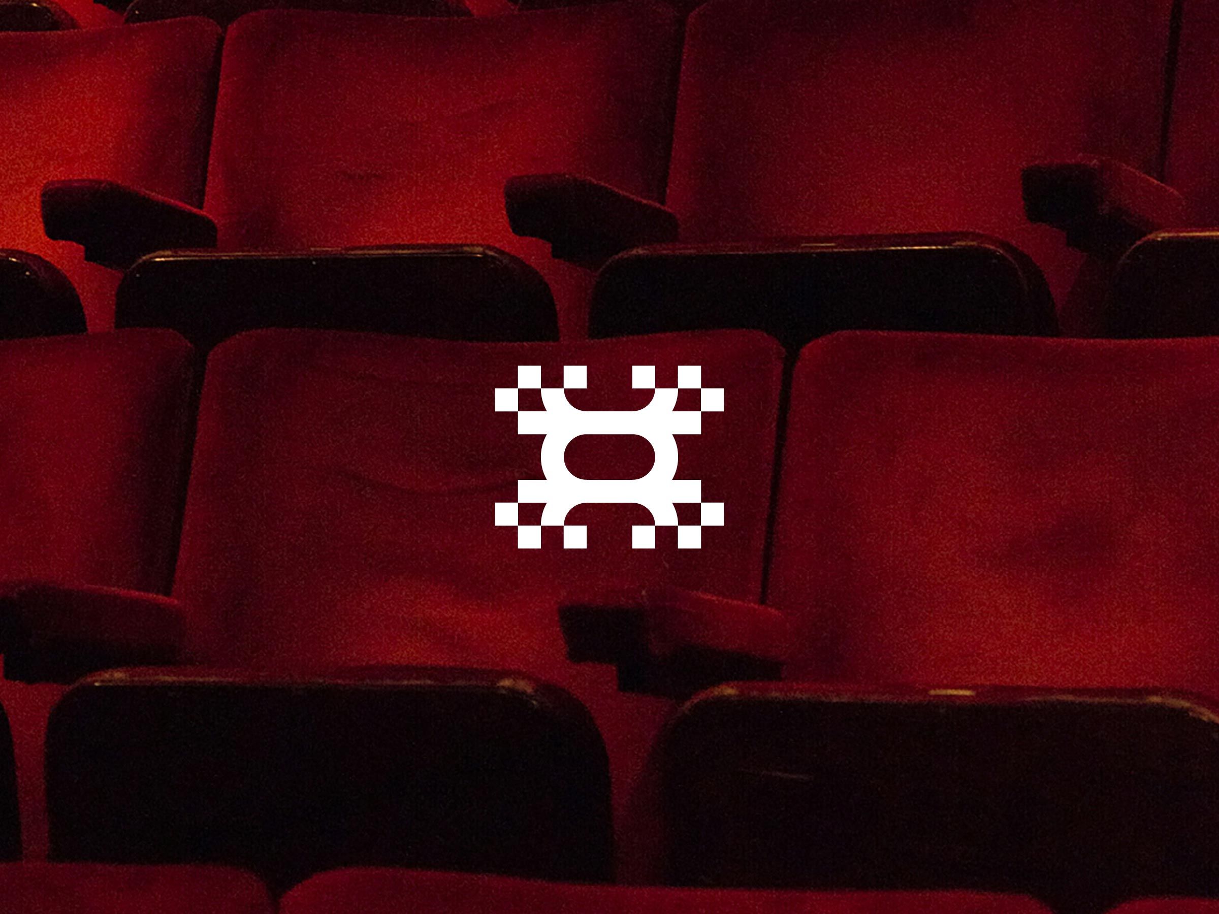 The Arena logo on a red cinema seat, variant 4 of 6.