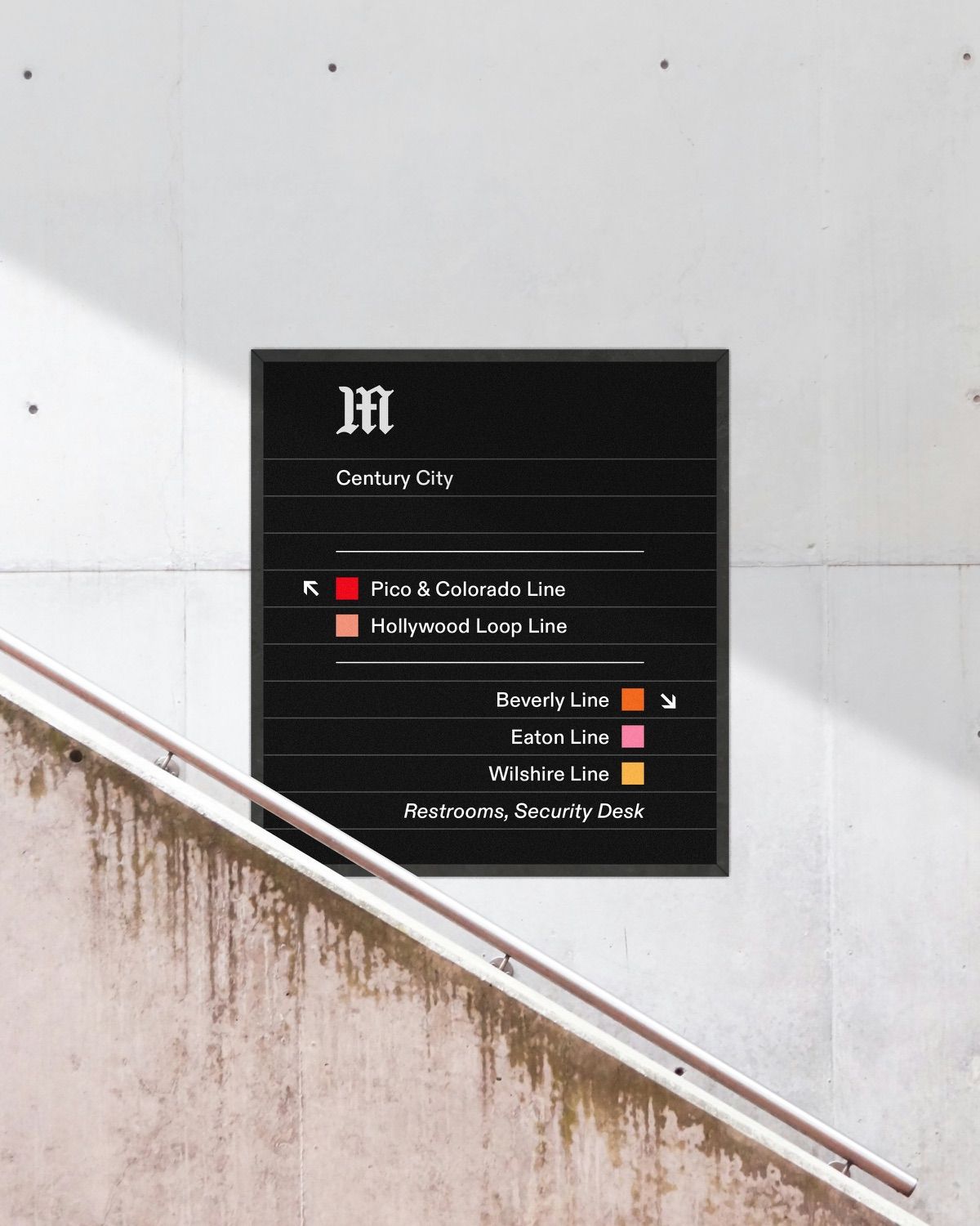 A wall-mounted station sign for Century City beside a concrete stair.